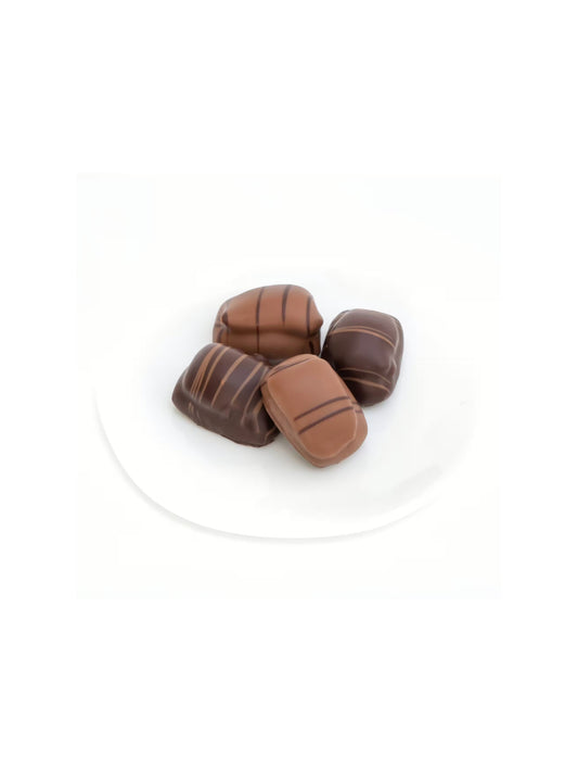 Marc de Champagne-Printen 100 g von Peters Pralinen – edles Weihnachtsgebäck mit feinen Gewürzen, Nougat- oder Marzipanfüllung, umhüllt von Vollmilch- oder Zartbitterschokolade, erhältlich in der Dreyer Confiserie in der Rattenfängerstadt Hameln.