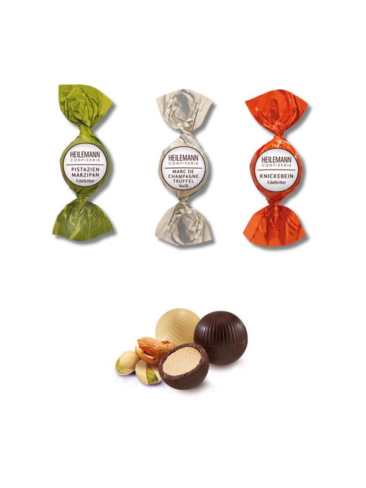 Produktbilder und Inhalt von Heilemann Christmas Mix mit Trüffel-Kugeln 180 g – edle Geschenkverpackung mit gefüllten Trüffel-Kugeln in den Sorten Marc de Champagne, Knickebein und Pistazien-Marzipan.